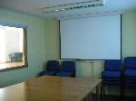 Small meeting room with projector and screen.  Seats 25.